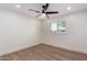 Bright bedroom features hardwood floors, fan, and a window with plantation shutters at 829 E Desert Park Ln, Phoenix, AZ 85020