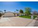 A well-manicured lawn enhances this single-story home, complete with a two-car garage at 829 E Desert Park Ln, Phoenix, AZ 85020