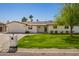 A charming single-story home with an attached garage, green lawn, and inviting front yard at 829 E Desert Park Ln, Phoenix, AZ 85020