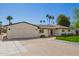 Single-story home boasting a well-manicured lawn, garage, and brick accents at 829 E Desert Park Ln, Phoenix, AZ 85020