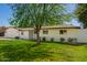 Quaint single-story home with a lush lawn, mature trees, and a welcoming facade at 829 E Desert Park Ln, Phoenix, AZ 85020