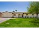 Lovely single-story home with green lawn, brick accents and a two-car garage at 829 E Desert Park Ln, Phoenix, AZ 85020