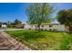 A charming single-story home featuring a well-manicured lawn and mature trees at 829 E Desert Park Ln, Phoenix, AZ 85020