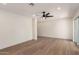 Spacious living room with hardwood floors, ceiling fan, and sliding glass doors to the backyard at 829 E Desert Park Ln, Phoenix, AZ 85020