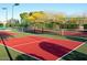 Active community living with pickleball court, green fence, shade trees, and blue benches at 8500 E Southern Ave # 463, Mesa, AZ 85209