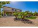 Lush backyard with palm trees, decorative rock, and a covered patio for relaxed outdoor living at 9382 W Louise Dr, Peoria, AZ 85383