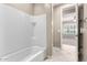 Bright bathroom features a white tiled shower-tub with a standard shower head at 9382 W Louise Dr, Peoria, AZ 85383