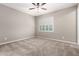 Bedroom with neutral carpet, light walls, ceiling fan, and shuttered window at 9382 W Louise Dr, Peoria, AZ 85383