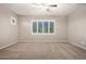 Bedroom with neutral carpet, ceiling fan, and bright windows at 9382 W Louise Dr, Peoria, AZ 85383