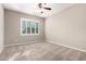 Bedroom with neutral carpet, light walls, ceiling fan, and shuttered window at 9382 W Louise Dr, Peoria, AZ 85383