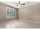 Bedroom with tile floors, ceiling fan, and large window with shutters at 9382 W Louise Dr, Peoria, AZ 85383