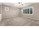 Bedroom with neutral carpet, ceiling fan, and bright windows at 9382 W Louise Dr, Peoria, AZ 85383