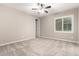 Bright bedroom with neutral paint, ceiling fan, and carpet flooring at 9382 W Louise Dr, Peoria, AZ 85383