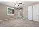 Bedroom with plush carpet, natural light, and walk-in closet at 9382 W Louise Dr, Peoria, AZ 85383