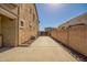 Long driveway with a view of backyard fence and the side of the home at 9382 W Louise Dr, Peoria, AZ 85383