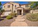 Two-story home with brick walkway, desert landscaping, and a two car garage at 9382 W Louise Dr, Peoria, AZ 85383