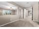 Neutral hallway with carpet flooring and natural lighting beaming from the nearby window at 9382 W Louise Dr, Peoria, AZ 85383