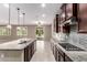 This kitchen features granite counters, dark cabinets, stainless appliances and an eat-in kitchen at 9382 W Louise Dr, Peoria, AZ 85383