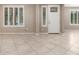 Living room featuring tile floors, white door and white shuttered windows at 9382 W Louise Dr, Peoria, AZ 85383