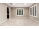 Neutral living room featuring tile floors, white shuttered windows, and tan walls at 9382 W Louise Dr, Peoria, AZ 85383