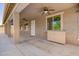 Covered patio featuring ceiling fans and a convenient built-in cabinet for outdoor storage at 9382 W Louise Dr, Peoria, AZ 85383