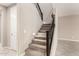 Carpeted staircase with decorative black metal railing and accent lighting at 9382 W Louise Dr, Peoria, AZ 85383