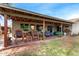 Extended back patio with lounging furniture, string lights, and barbecue area at 947 N Saffron --, Mesa, AZ 85205