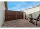 A backyard gate with a basketball hoop in the background and various cut wood pieces on the ground at 947 N Saffron --, Mesa, AZ 85205