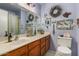 Bathroom featuring beach-themed decorations, including wreaths and decorative artwork, above the vanity at 947 N Saffron --, Mesa, AZ 85205