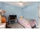 Bedroom featuring a desk, bed with a yellow pillow, gray carpet and blue walls at 947 N Saffron --, Mesa, AZ 85205