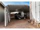 A sheltered carport features a trailer with a covered boat providing secure storage at 947 N Saffron --, Mesa, AZ 85205