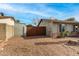 Residential house featuring wooden driveway gate at 947 N Saffron --, Mesa, AZ 85205