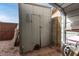 A storage shed features double doors under a car port, with various items on the ground at 947 N Saffron --, Mesa, AZ 85205