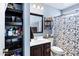 Stylish bathroom with decorative shelving, vanity and black and white shower curtain provides a comfortable and functional space at 949 E Piute Ave, Phoenix, AZ 85024