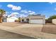 Beautiful single-story home featuring a two-car garage, desert landscaping, and blue sky at 949 E Piute Ave, Phoenix, AZ 85024