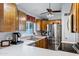 Well-lit kitchen with stainless steel appliances, wood cabinets and white countertops, offering ample storage and workspace at 949 E Piute Ave, Phoenix, AZ 85024