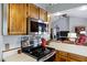 This kitchen features stainless steel appliances, wood cabinets and is open to the living room for easy entertaining at 949 E Piute Ave, Phoenix, AZ 85024