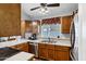 Functional kitchen with wood cabinets, stainless steel appliances, and a view to the backyard at 949 E Piute Ave, Phoenix, AZ 85024