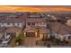 Aerial view of a home with a brown roof in a neighborhood at sunset at 9730 E Resistance Ave, Mesa, AZ 85212