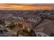 Aerial view of a home with a brown roof in a neighborhood at sunset at 9730 E Resistance Ave, Mesa, AZ 85212