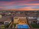 Aerial backyard view of a home featuring a pool and seating at dusk at 9730 E Resistance Ave, Mesa, AZ 85212