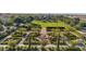 Aerial view of a neighborhood park with brick walkways, fire pit, and shaded seating areas surrounded by lush greenery at 9730 E Resistance Ave, Mesa, AZ 85212