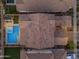 Aerial view of a home featuring a backyard pool and seating at dusk at 9730 E Resistance Ave, Mesa, AZ 85212