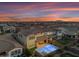 Aerial backyard view of a home featuring a pool and seating at dusk at 9730 E Resistance Ave, Mesa, AZ 85212