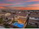 Aerial view of a backyard, featuring a pool, outdoor seating, and mural at dusk at 9730 E Resistance Ave, Mesa, AZ 85212