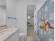 bathroom featuring a single sink vanity with marble countertop and a playful shower curtain at 9730 E Resistance Ave, Mesa, AZ 85212