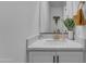 Bright bathroom featuring white cabinets, a quartz countertop, and a gold faucet at 9730 E Resistance Ave, Mesa, AZ 85212