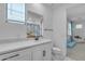 Bright bathroom features a single sink vanity with white marble countertop and an adjacent toilet at 9730 E Resistance Ave, Mesa, AZ 85212