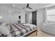 Spacious bedroom with a sliding barn door, a ceiling fan, and a cozy beanbag chair at 9730 E Resistance Ave, Mesa, AZ 85212