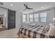 Bedroom featuring a sliding barn door, three windows, and a comfortable beanbag chair at 9730 E Resistance Ave, Mesa, AZ 85212